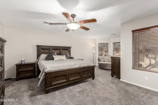 bedroom with ceiling fan and dark colored carpet