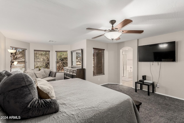 carpeted bedroom with ceiling fan and ensuite bathroom