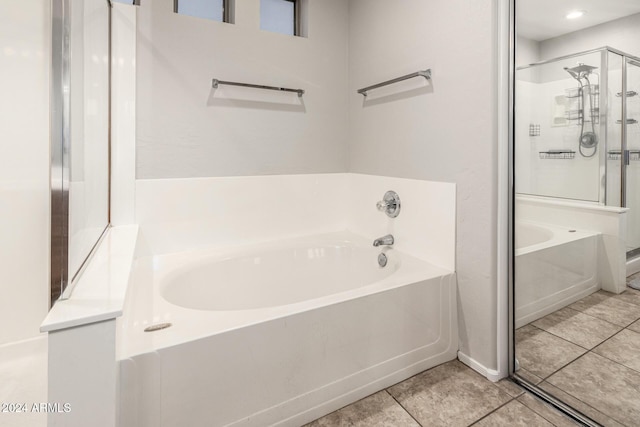 bathroom featuring tile patterned flooring and independent shower and bath