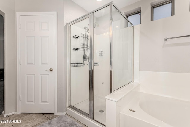 bathroom featuring tile patterned flooring and plus walk in shower