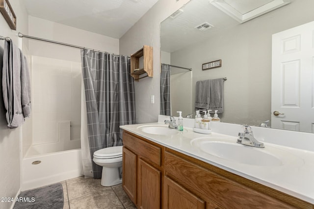 full bathroom with tile patterned floors, shower / bath combo, toilet, and vanity