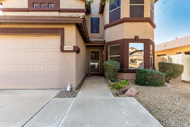 view of exterior entry featuring a garage