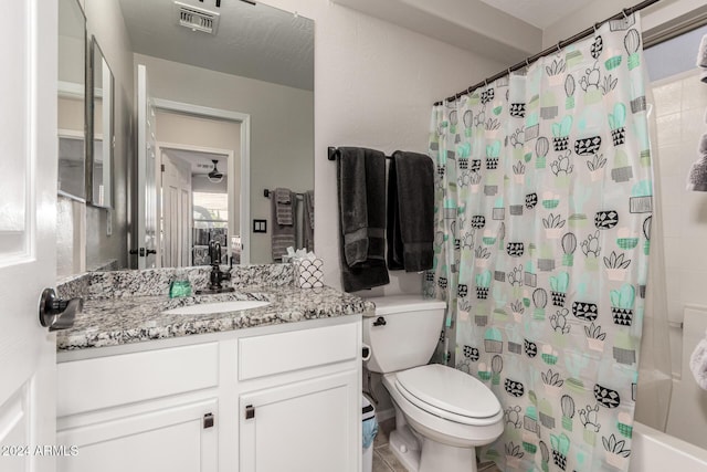 full bathroom featuring shower / tub combo, vanity, and toilet