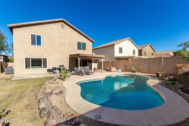 view of swimming pool featuring a patio area and central air condition unit