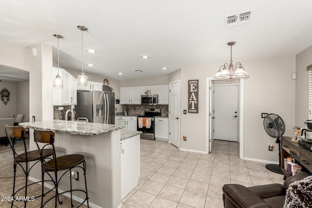 kitchen featuring hanging light fixtures, white cabinetry, kitchen peninsula, and appliances with stainless steel finishes