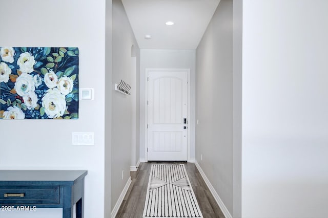 doorway with recessed lighting, dark wood-type flooring, and baseboards