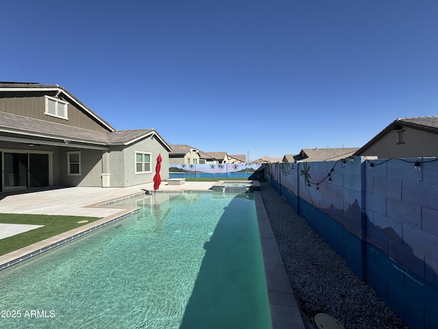 view of swimming pool featuring a patio, a pool with connected hot tub, and a fenced backyard