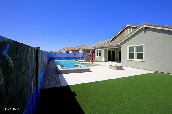 view of pool featuring a yard, a patio area, a fenced in pool, and a fenced backyard