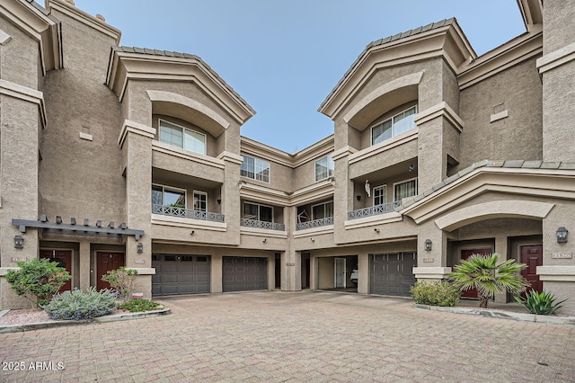 view of building exterior with driveway and an attached garage