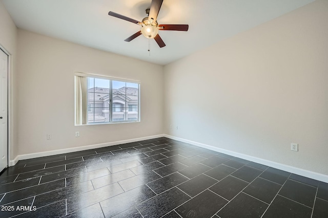 unfurnished room with baseboards and ceiling fan