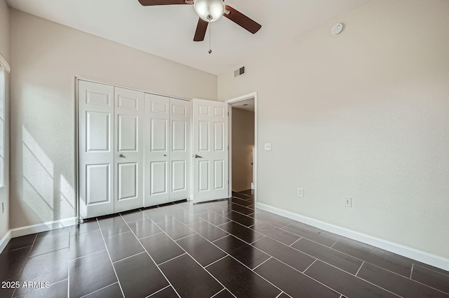 unfurnished bedroom featuring baseboards, visible vents, a closet, and ceiling fan