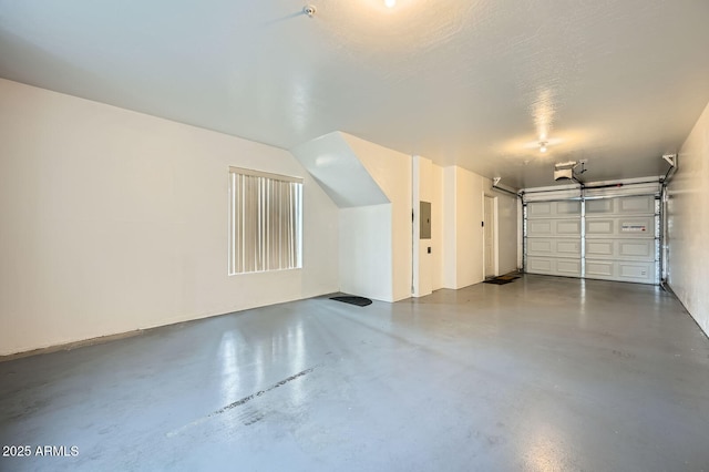 garage featuring electric panel and a garage door opener