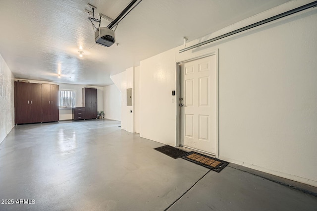 garage featuring electric panel and a garage door opener