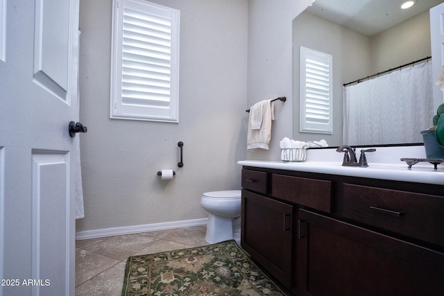 bathroom featuring tile patterned floors, vanity, and toilet