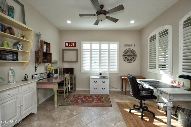 tiled office space featuring ceiling fan