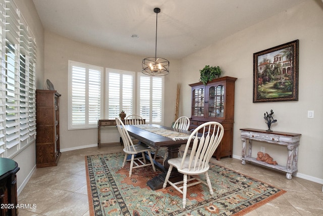 tiled dining area with a chandelier