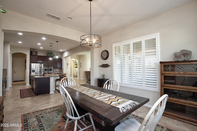 dining space featuring a notable chandelier