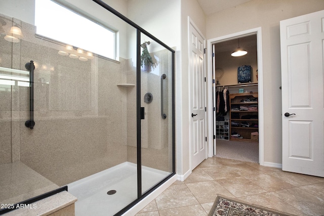 bathroom featuring tile patterned flooring and an enclosed shower