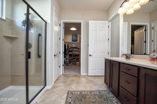 bathroom featuring vanity, tile patterned floors, and walk in shower