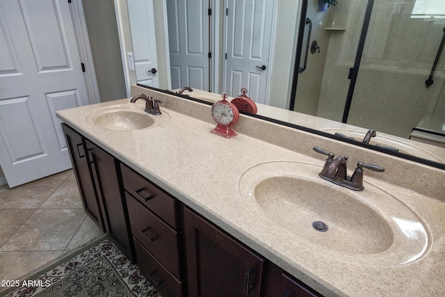 bathroom with tile patterned flooring, vanity, and an enclosed shower