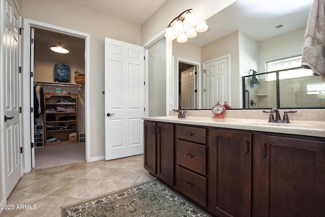 bathroom with tile patterned floors, vanity, and walk in shower