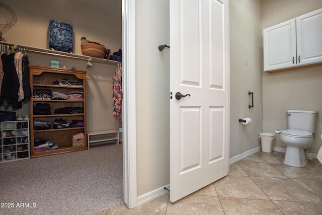 bathroom featuring tile patterned flooring and toilet