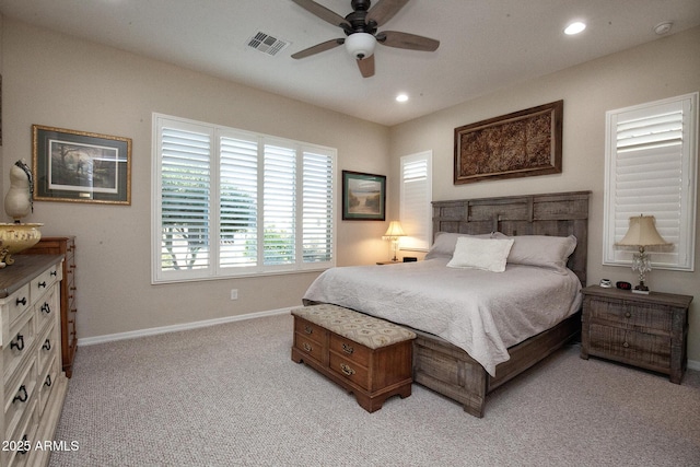 bedroom with ceiling fan and light carpet