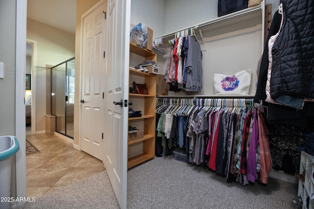 spacious closet with light tile patterned floors