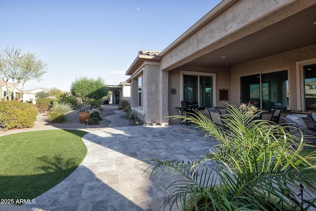 view of side of home featuring a patio area