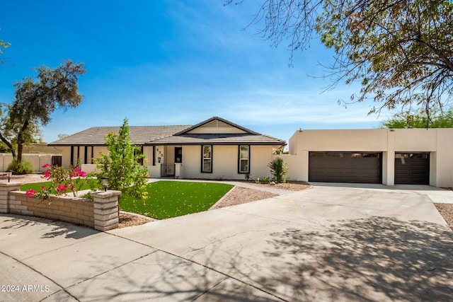 view of front of home featuring a garage and a front lawn