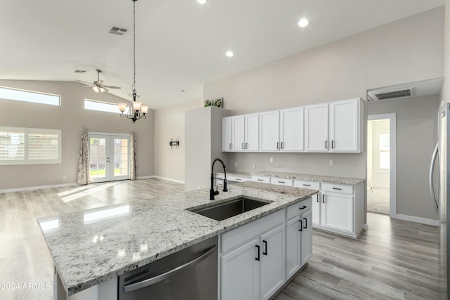 kitchen featuring appliances with stainless steel finishes, sink, white cabinetry, decorative light fixtures, and ceiling fan with notable chandelier