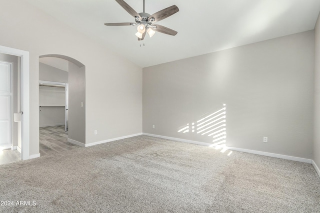 carpeted empty room featuring lofted ceiling and ceiling fan