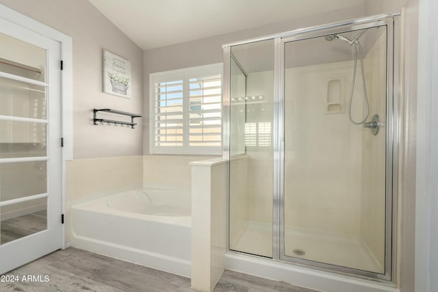 bathroom with independent shower and bath and hardwood / wood-style floors