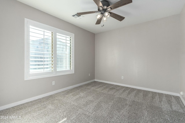 unfurnished room with ceiling fan and carpet