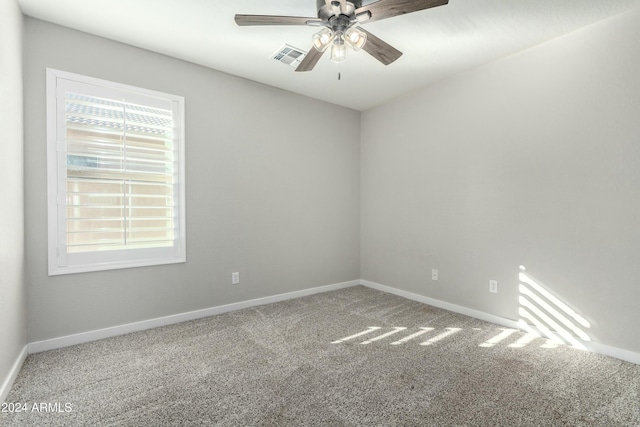 spare room featuring ceiling fan and carpet flooring