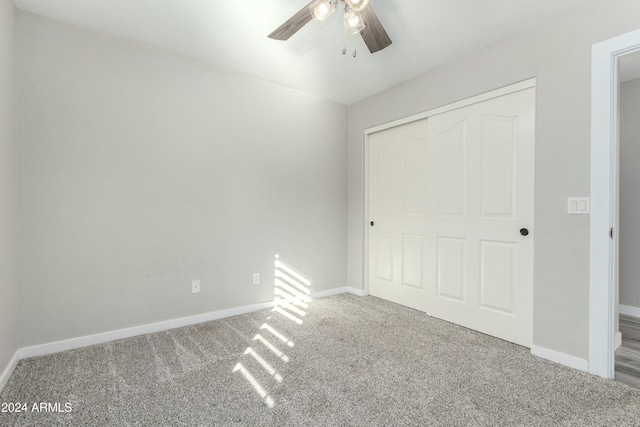 unfurnished bedroom featuring a closet, ceiling fan, and carpet flooring