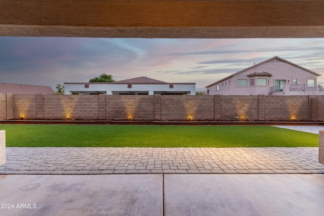 yard at dusk with a patio area