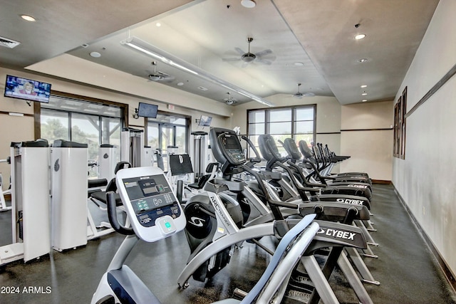 gym with lofted ceiling and ceiling fan