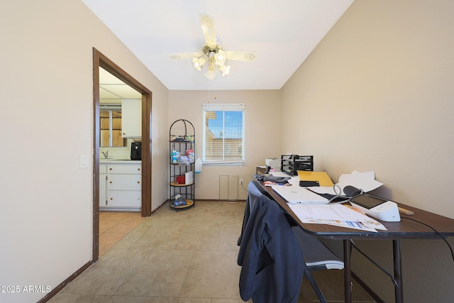 office space featuring a ceiling fan, light tile patterned flooring, and baseboards