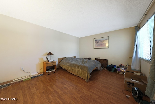 bedroom featuring wood finished floors and visible vents