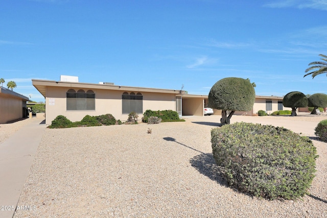 ranch-style house with stucco siding