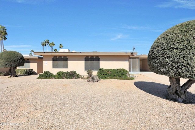 ranch-style house featuring stucco siding