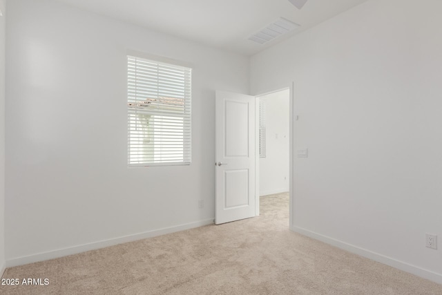 unfurnished room with visible vents, baseboards, and carpet flooring