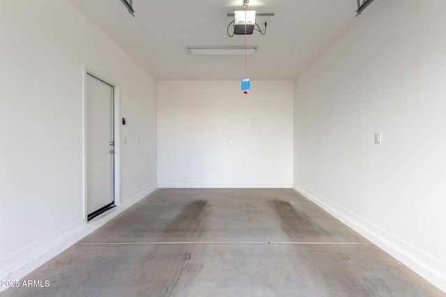 garage with a garage door opener and baseboards