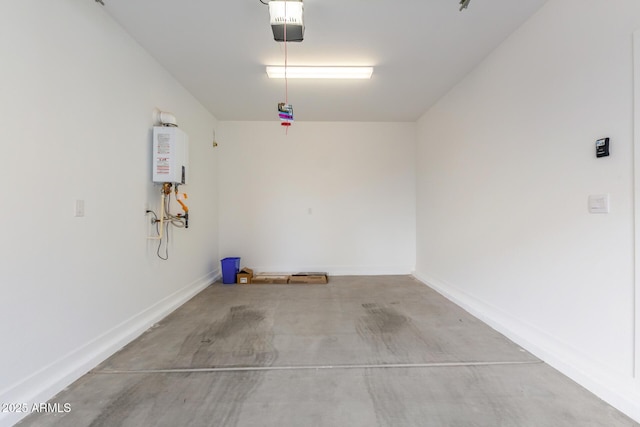 garage with a garage door opener, tankless water heater, and baseboards