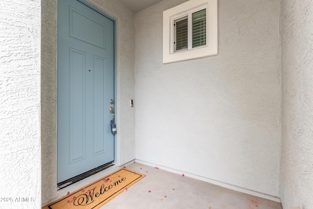 entrance to property with stucco siding