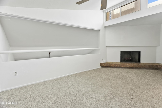 unfurnished living room featuring ceiling fan, carpet floors, and lofted ceiling