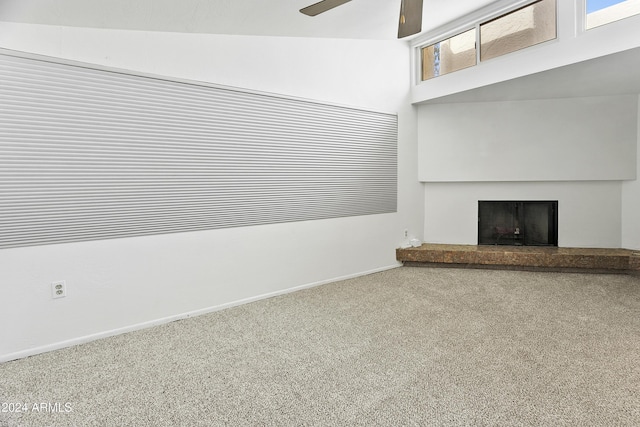 unfurnished living room featuring ceiling fan, carpet floors, and lofted ceiling