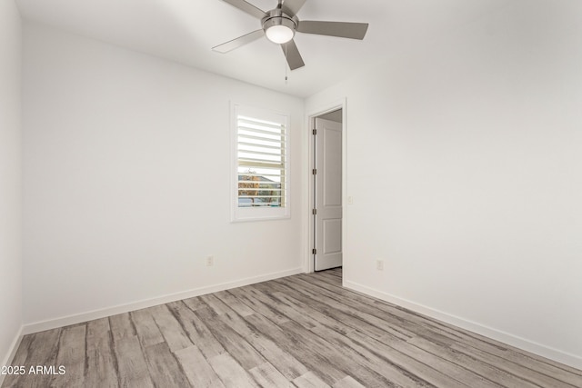 empty room featuring ceiling fan and light hardwood / wood-style floors