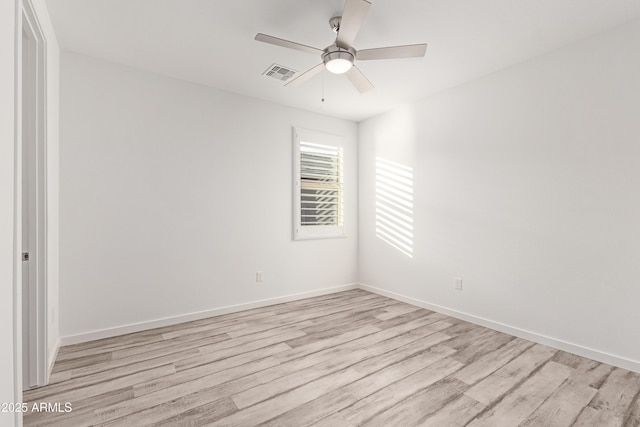 empty room with ceiling fan and light hardwood / wood-style flooring